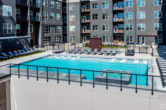 There is a large swimming pool in the middle of a building.