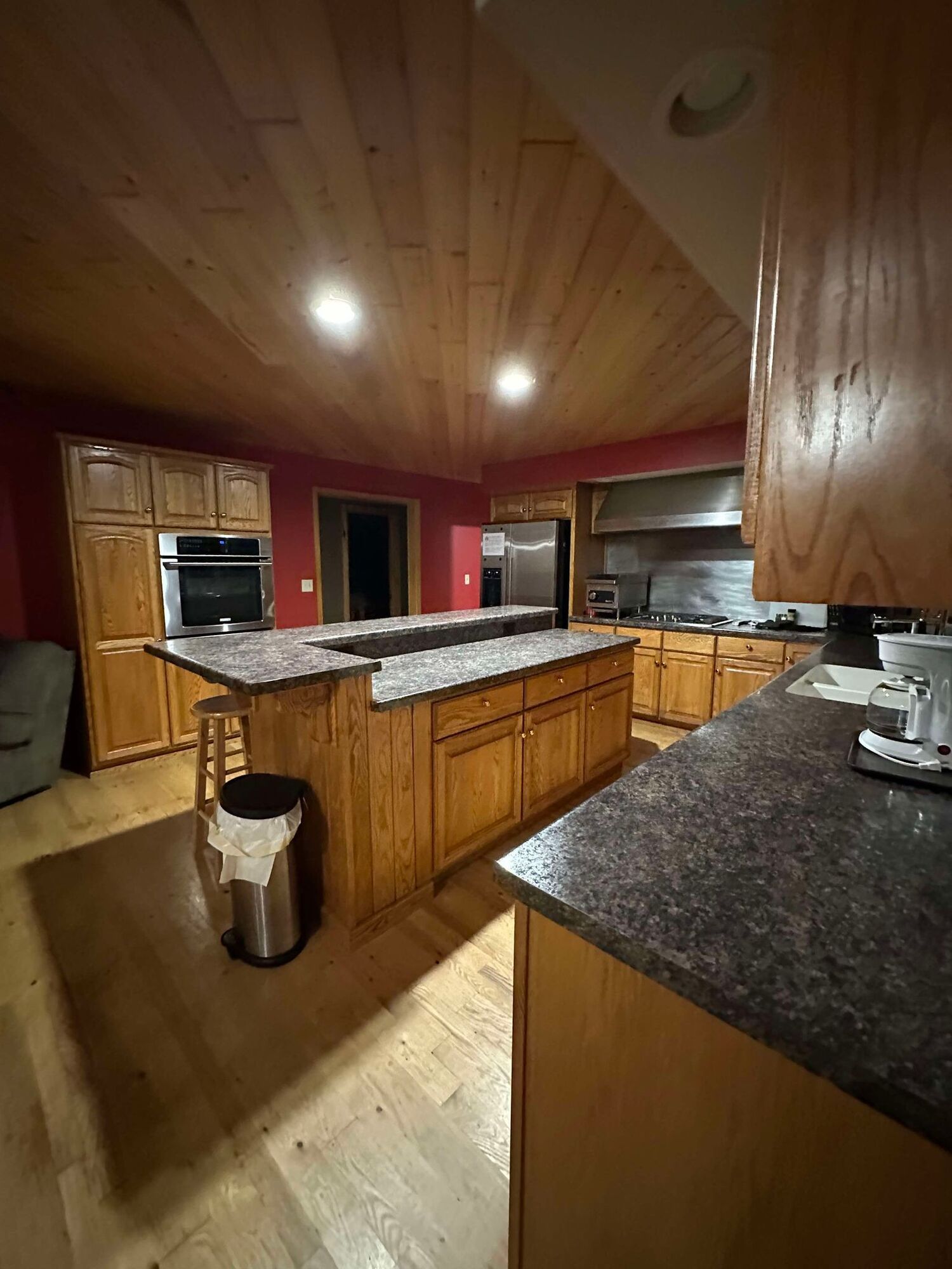 A kitchen with wooden cabinets and granite counter tops