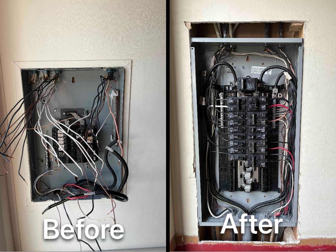 Technician in a blue hard hat inspecting wiring in an electrical control panel cabinet.