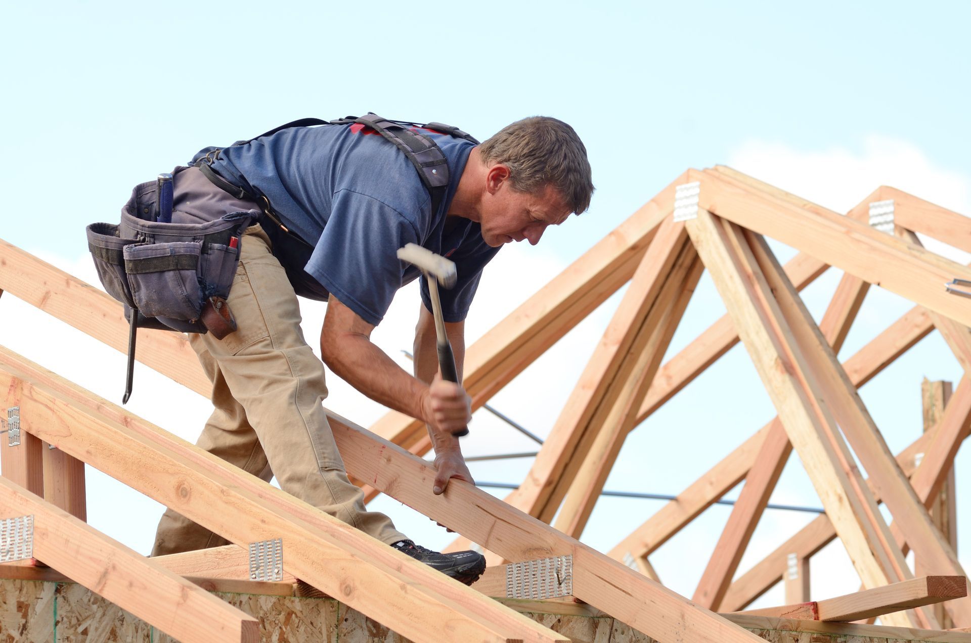 a man is working on a wooden structure with a hammer