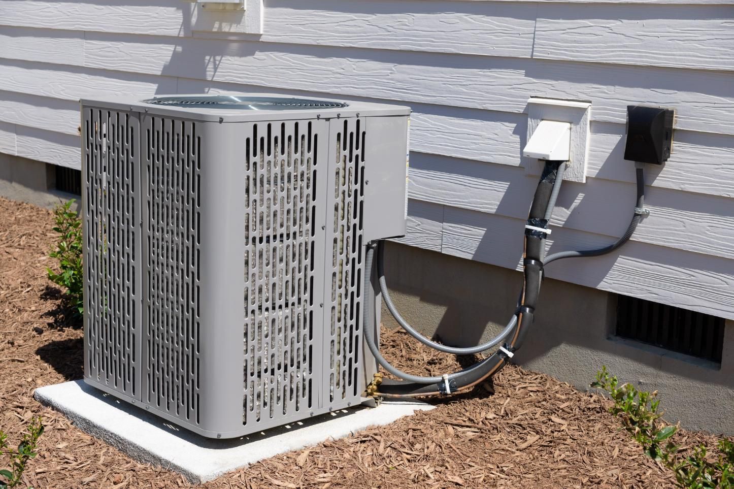 Air conditioning unit next to a house.