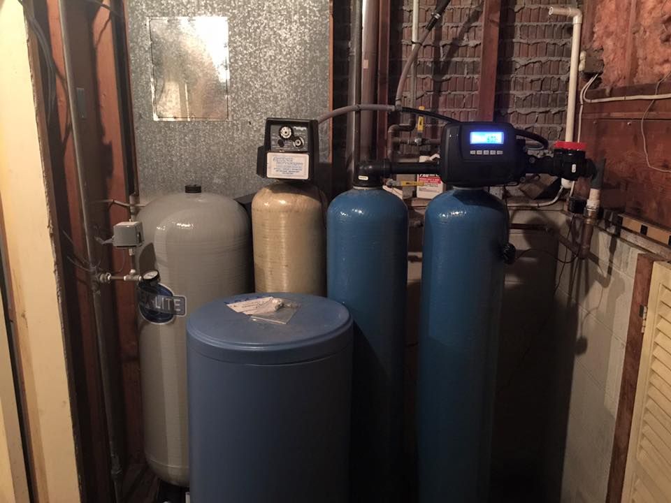 A room with a lot of water tanks and a water filter.
