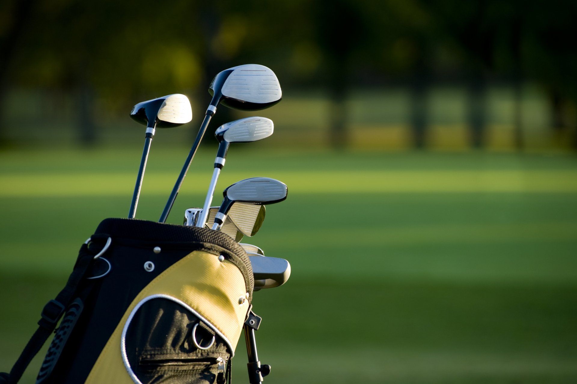 A set up new golf clubs on a beautiful golf course.