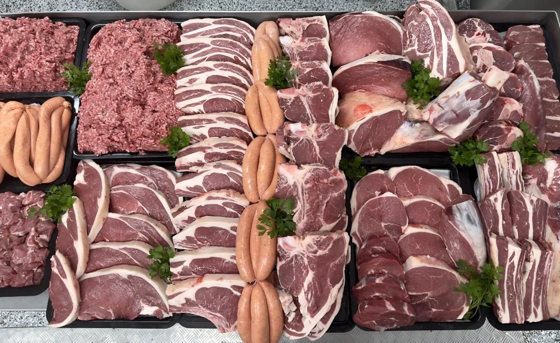 A Variety of Meats and Sausages Are Displayed on a Table — MBW Wholesale & Bulk In Cannonvale, QLD