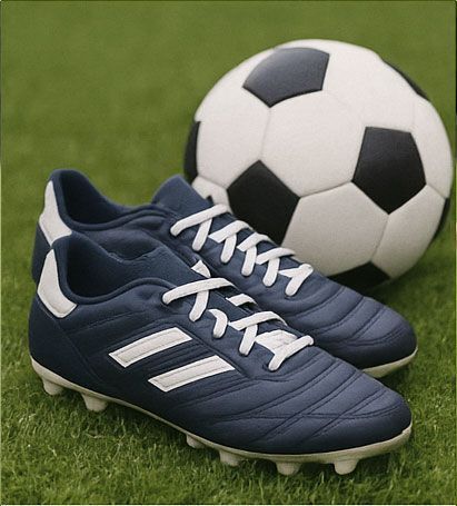 Soccer cleats and ball on green grass. Blue cleats with white stripes, white laces. Black and white ball.