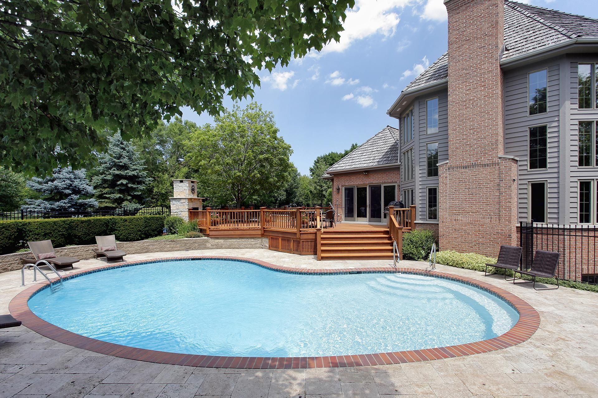 a large house with a large swimming pool in front of it