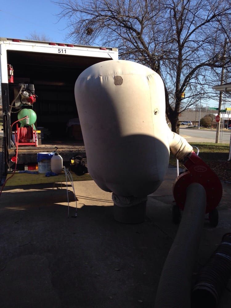 A large white object is sitting in front of a truck