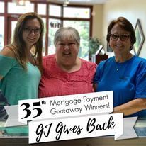 Three women are posing for a picture in a mortgage payment giveaway.