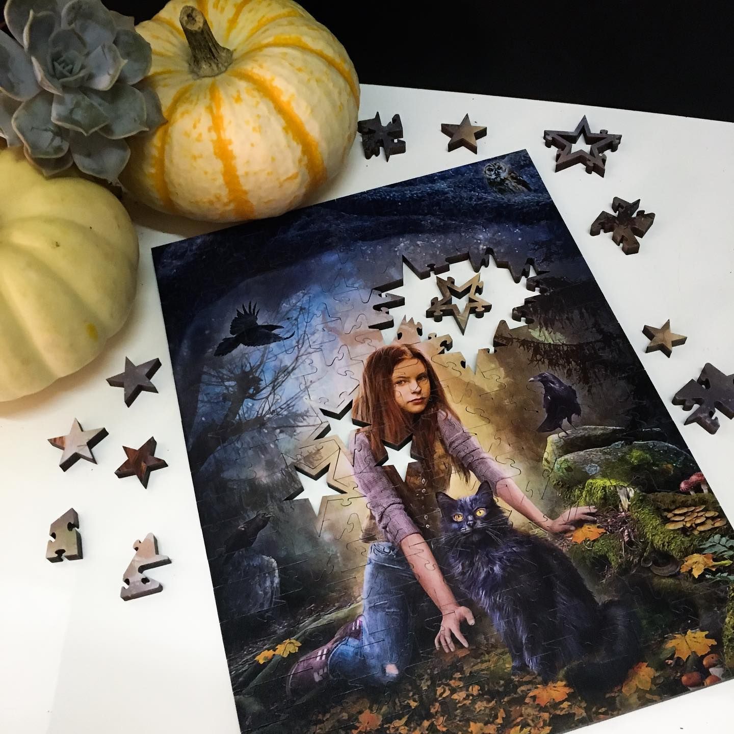 A picture of a girl surrounded by puzzle pieces and pumpkins