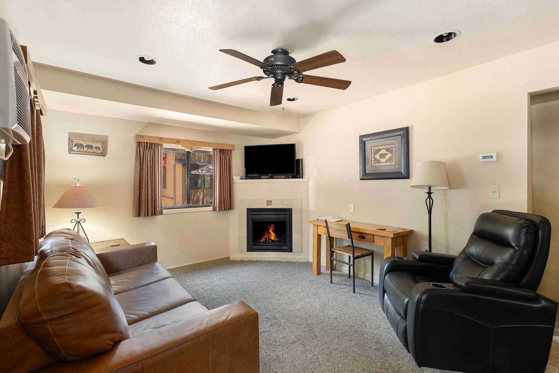 living room with sleeper sofa, recliner and fireplace