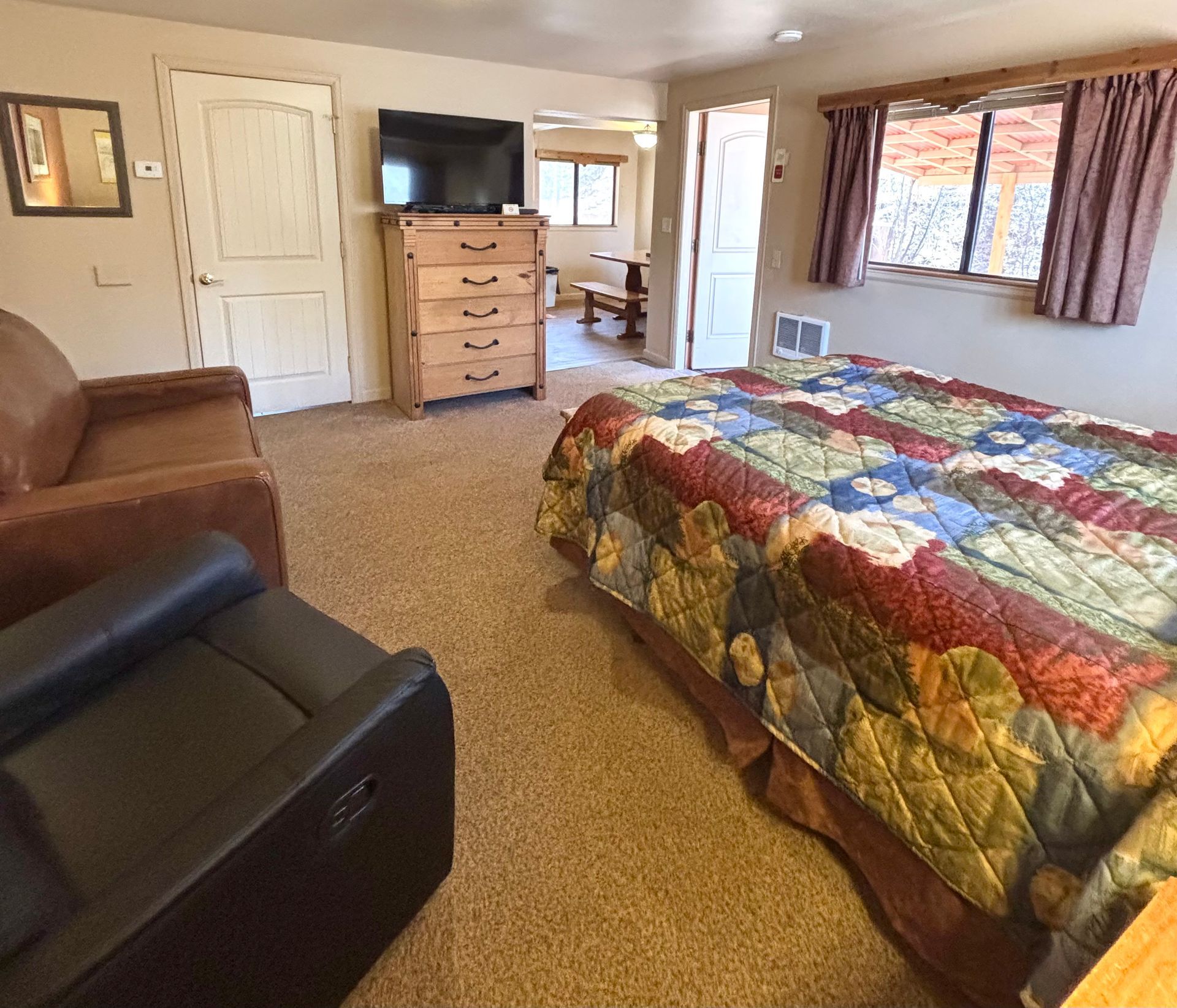 Bedroom with a bed, dresser, sofa, and recliner.
