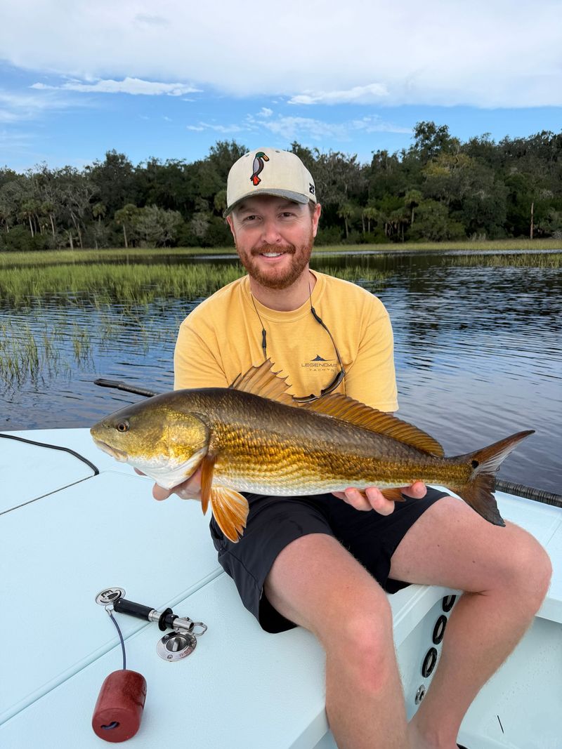 A customer holding a redfish