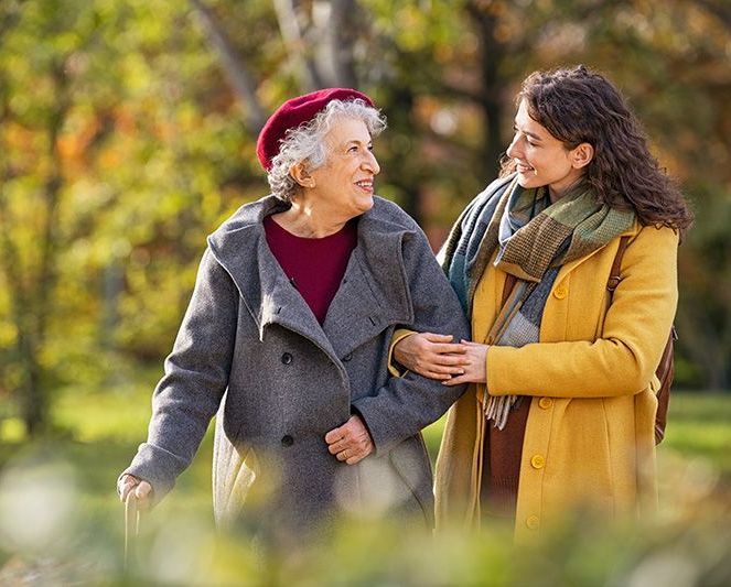 Mother and daughter walking in park