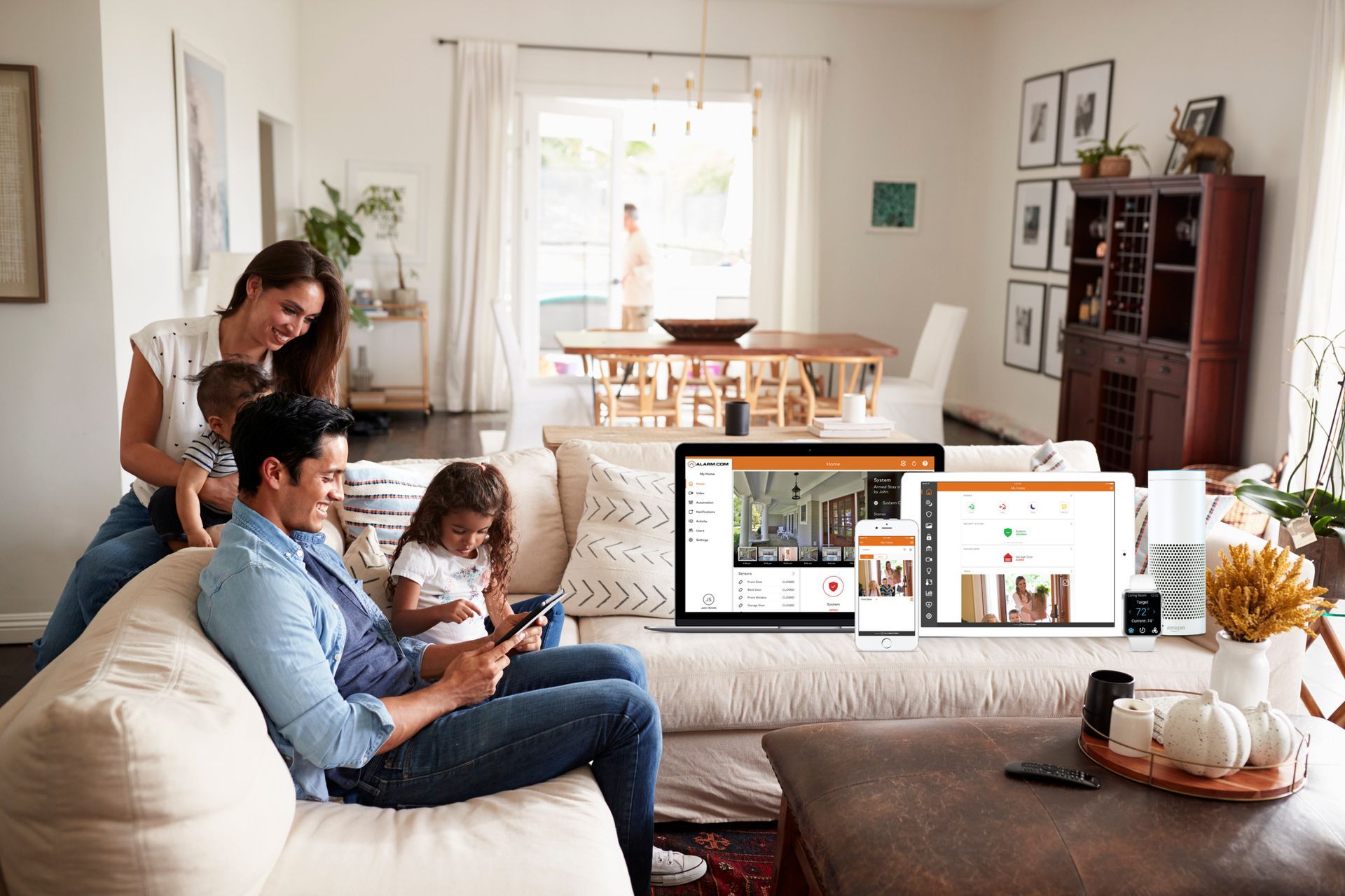 A family is sitting on a couch in a living room.