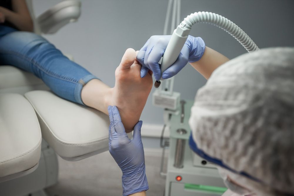 A Woman is Getting a Foot Treatment at a Beauty Salon — Maitland Central Podiatry in Maitland NSW