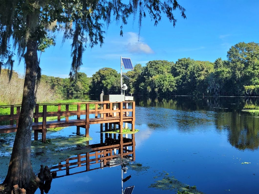 a wooden dock with a solar panel on top of it