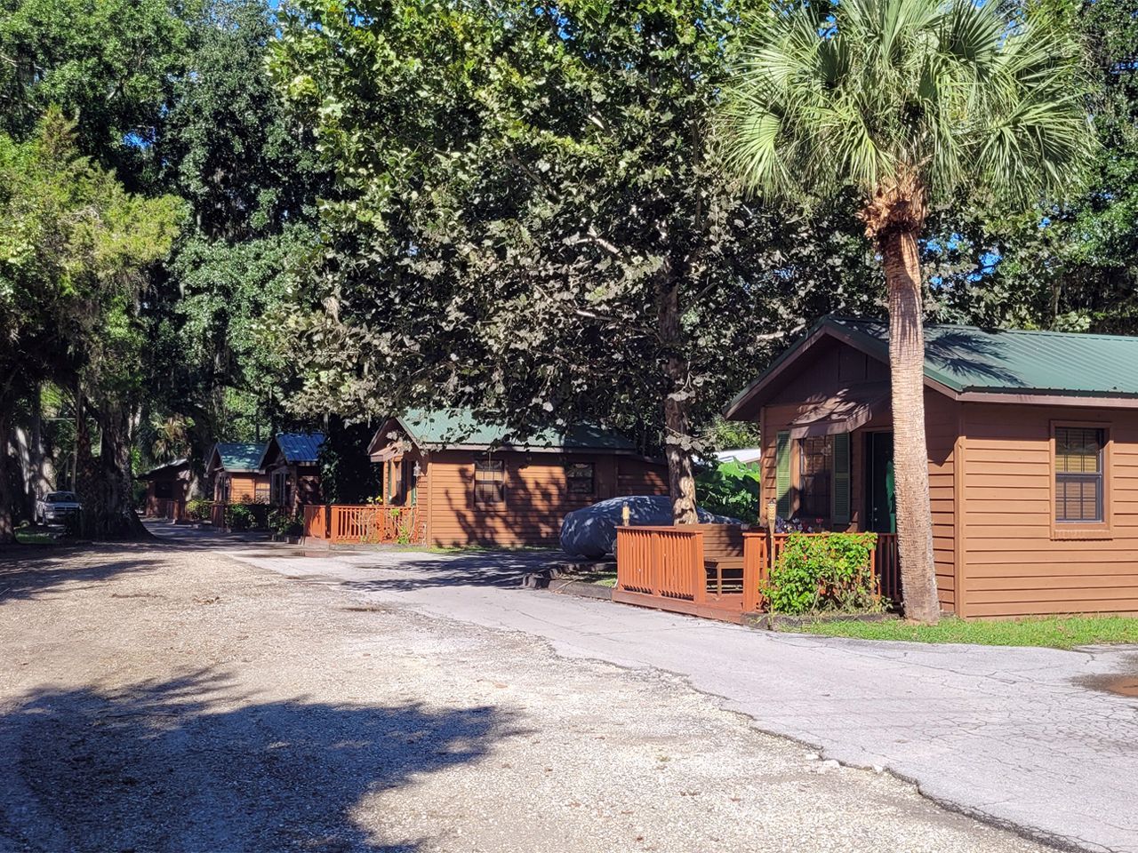 a group of cabins are sitting next to each other on a dirt road .