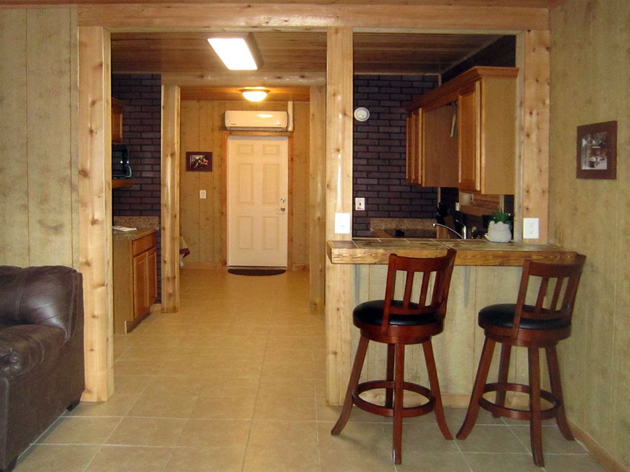 a living room with two bar stools and a couch