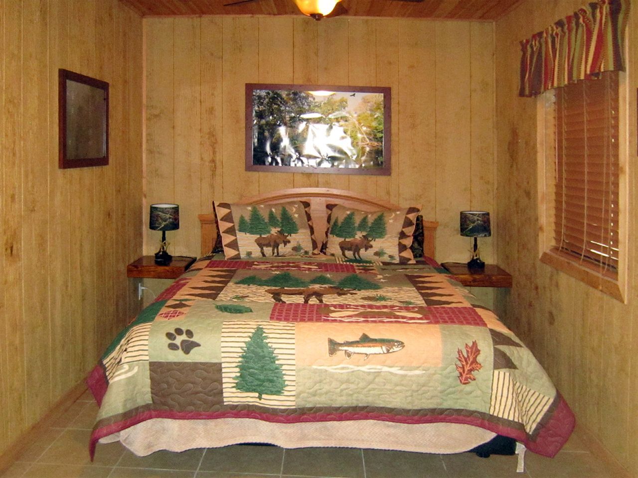 a bedroom with a bed and a mirror on the wall
