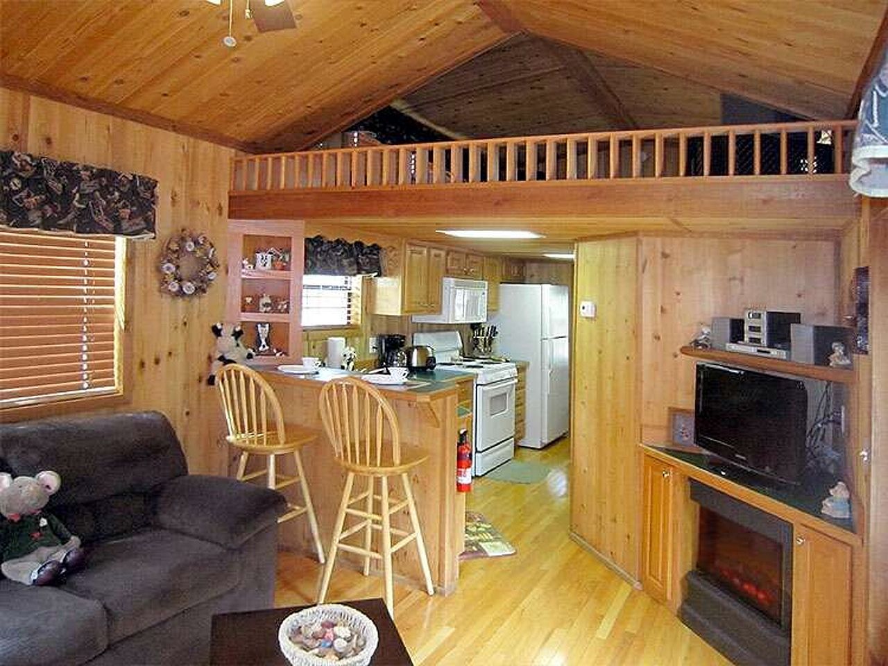 a living room with a couch and chairs and a fireplace