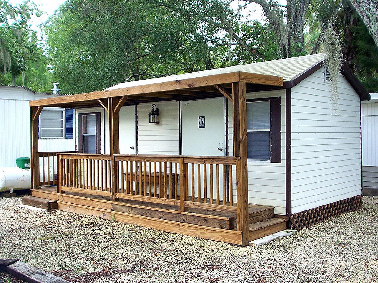 a small white house with a porch and stairs