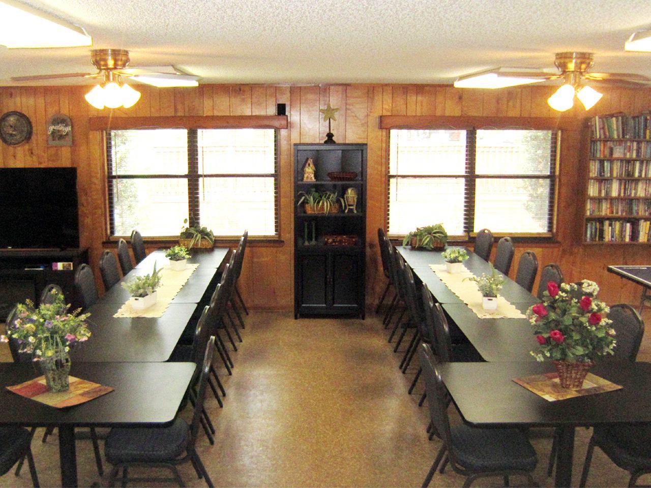a dining room with a long table and chairs