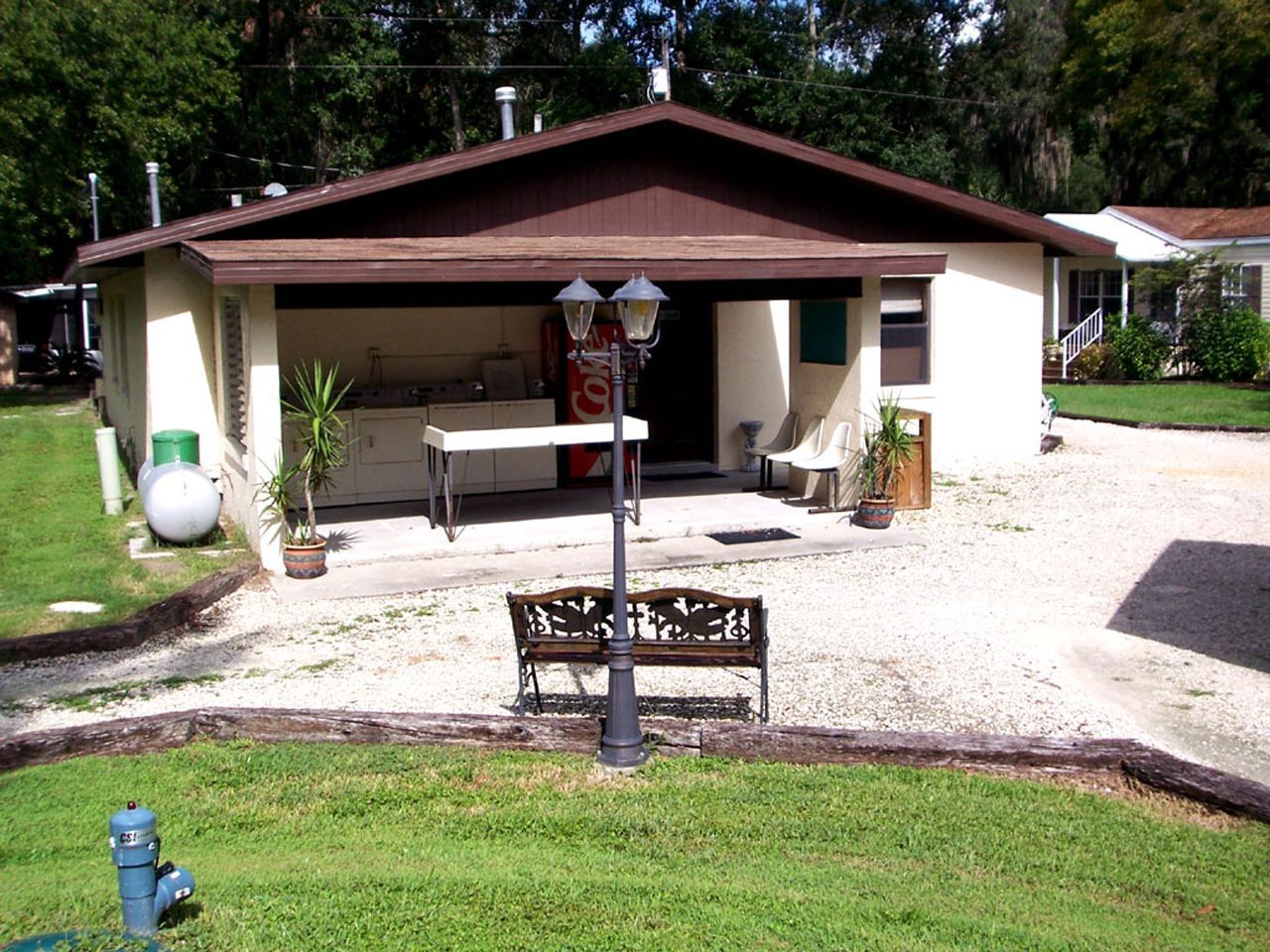 a coca cola vending machine sits in front of a house