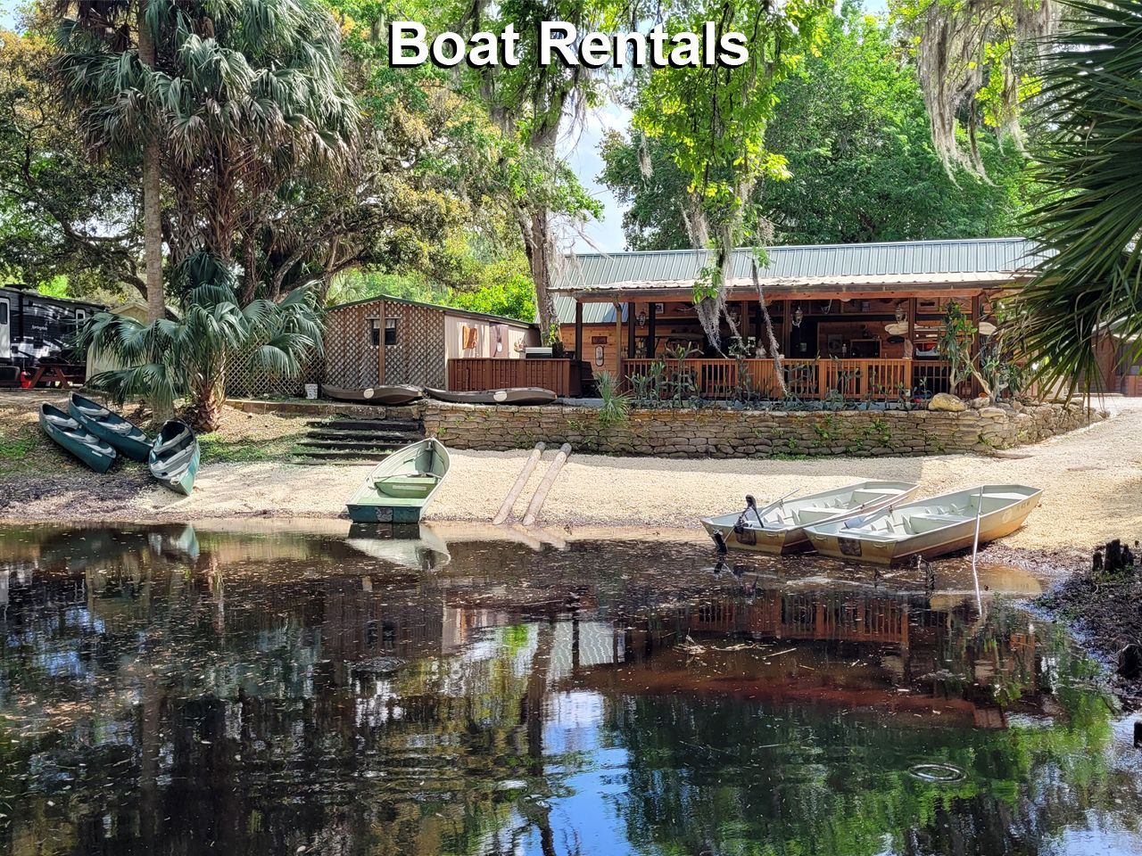 a boat is docked in front of a house next to a body of water .