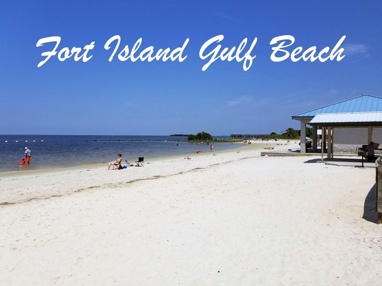 a picture of fort island gulf beach with people swimming in the water