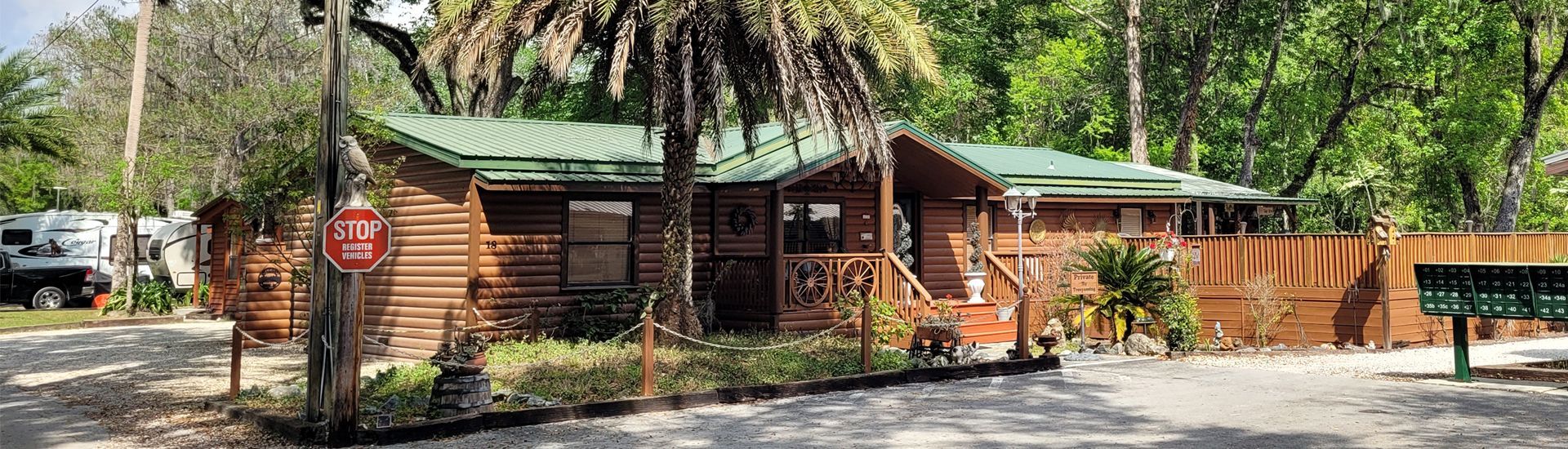 a wooden cabin with a stop sign in front of it .