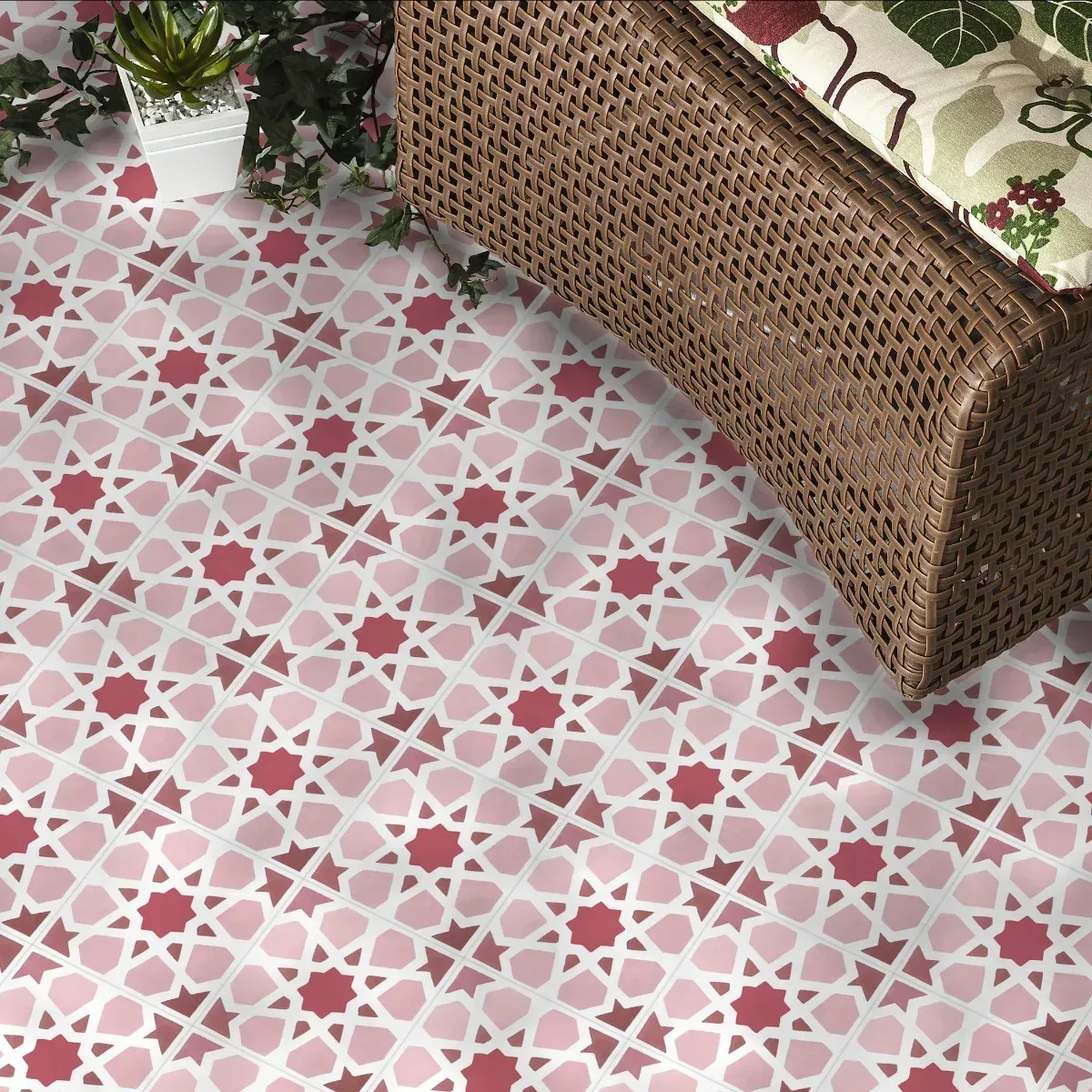 A wicker bench is sitting on a pink tiled floor next to a potted plant.