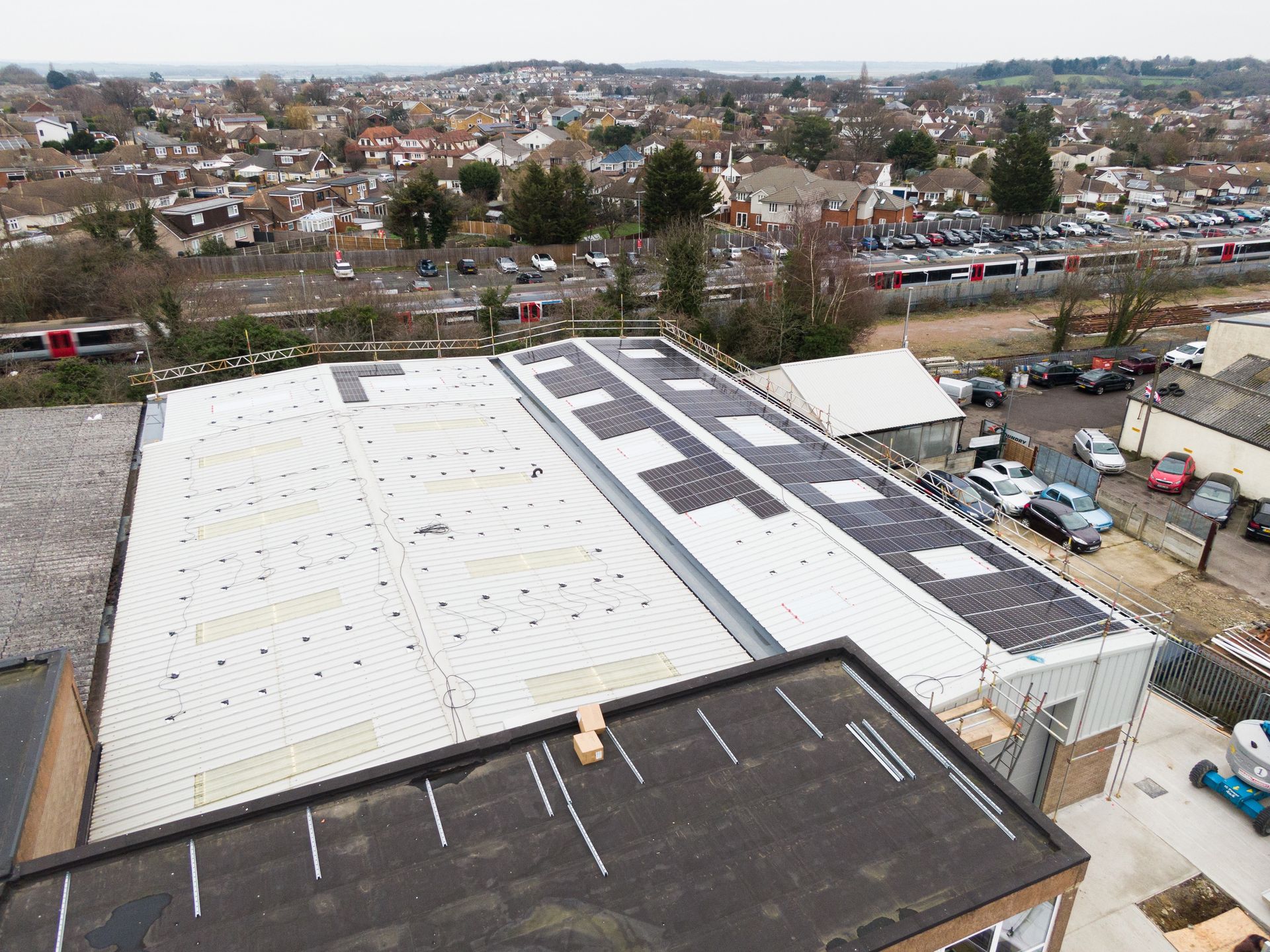 An aerial view of a building with solar panels on the roof.