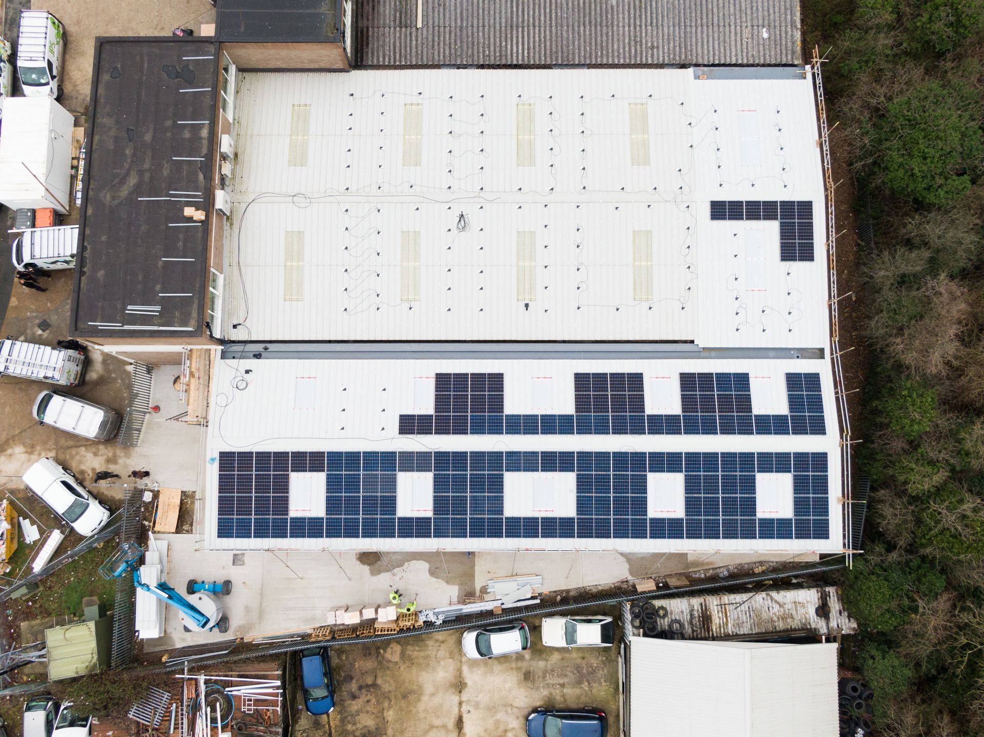 An aerial view of a building with solar panels on the roof