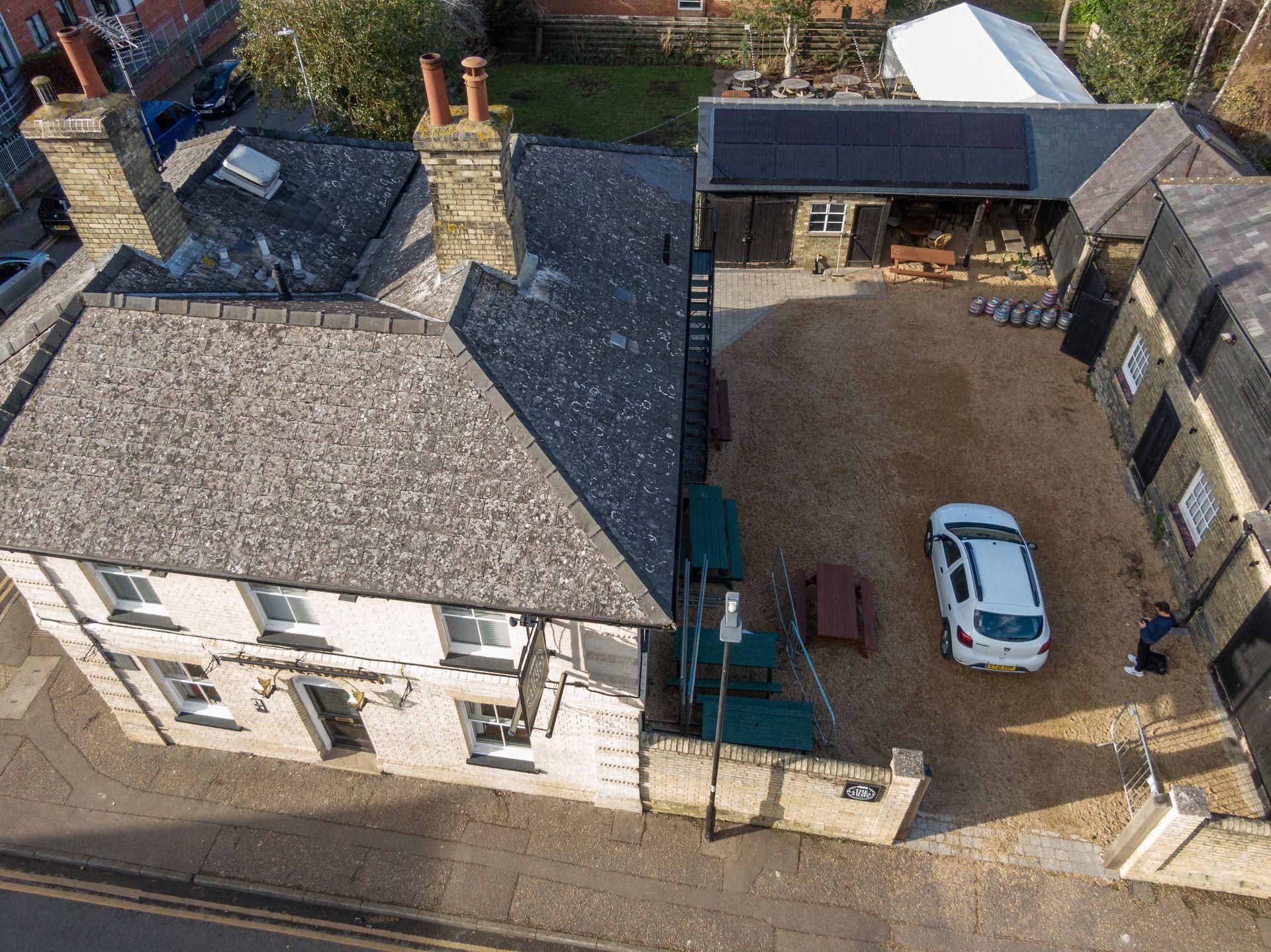 An aerial view of a house with a car parked in front of it.
