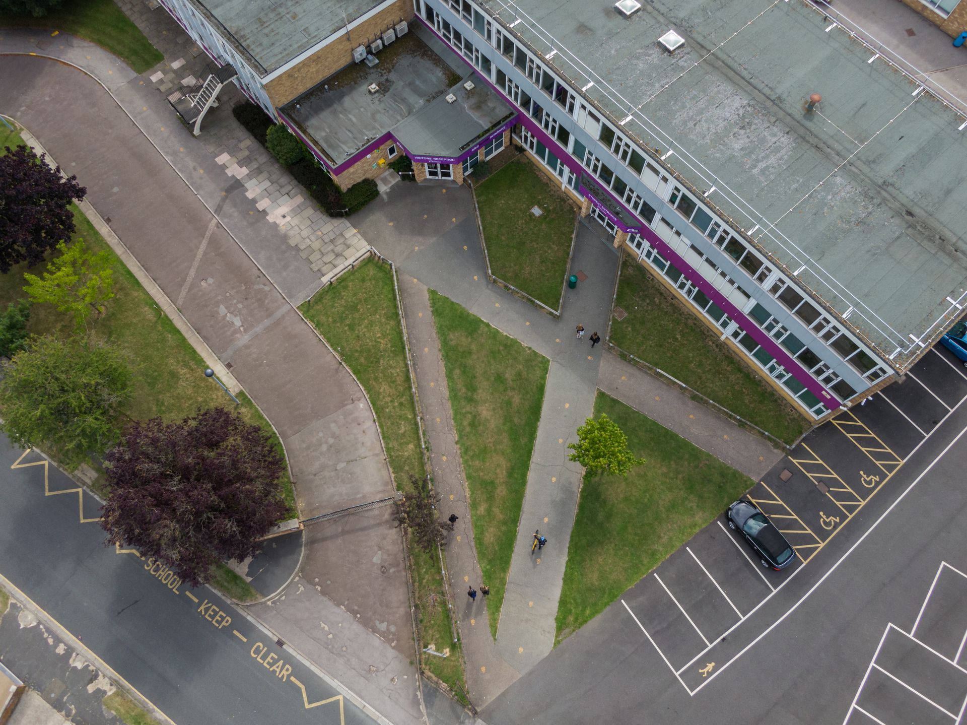 An aerial view of a building with a parking lot in front of it