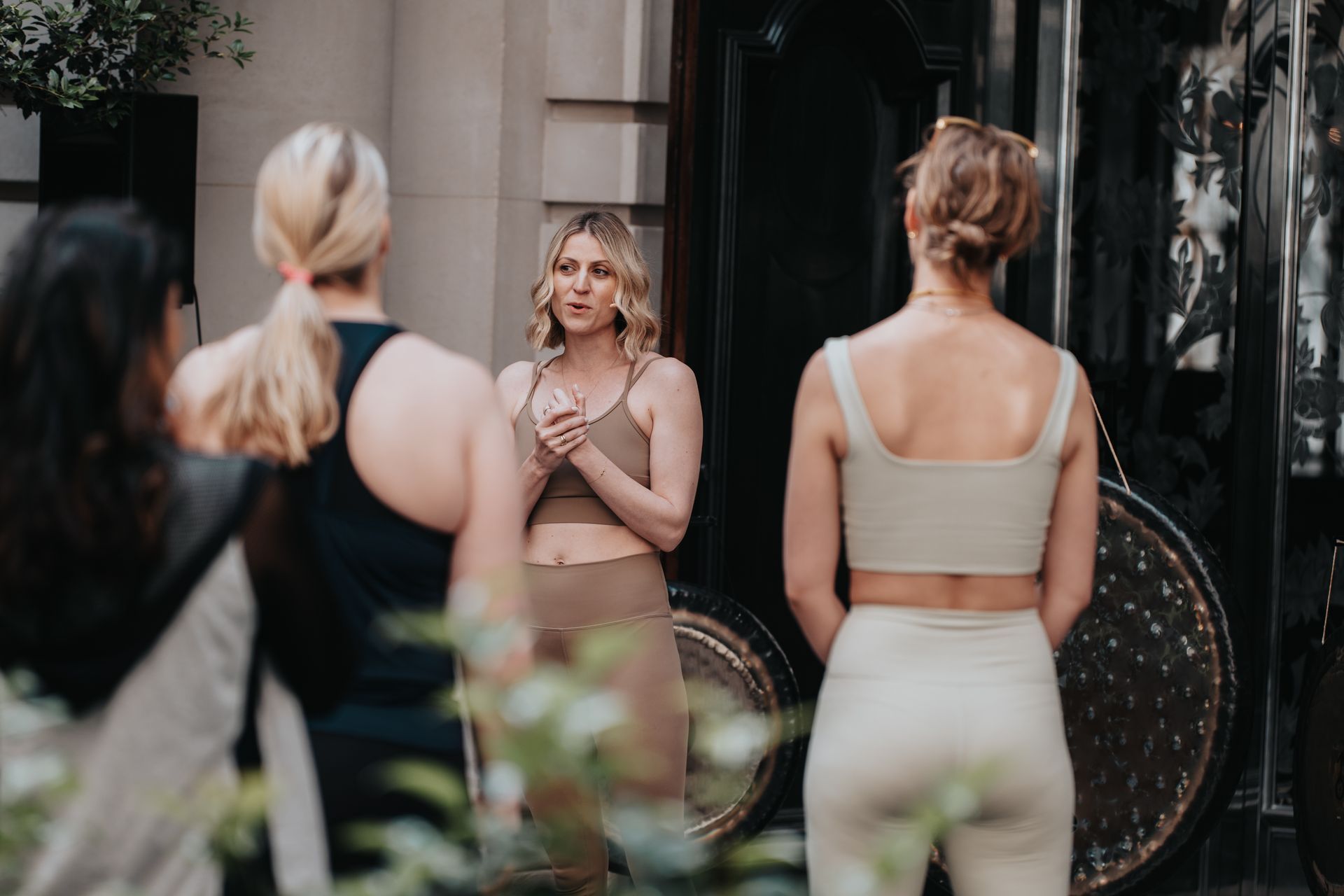 A group of women are standing next to each other in front of a building.