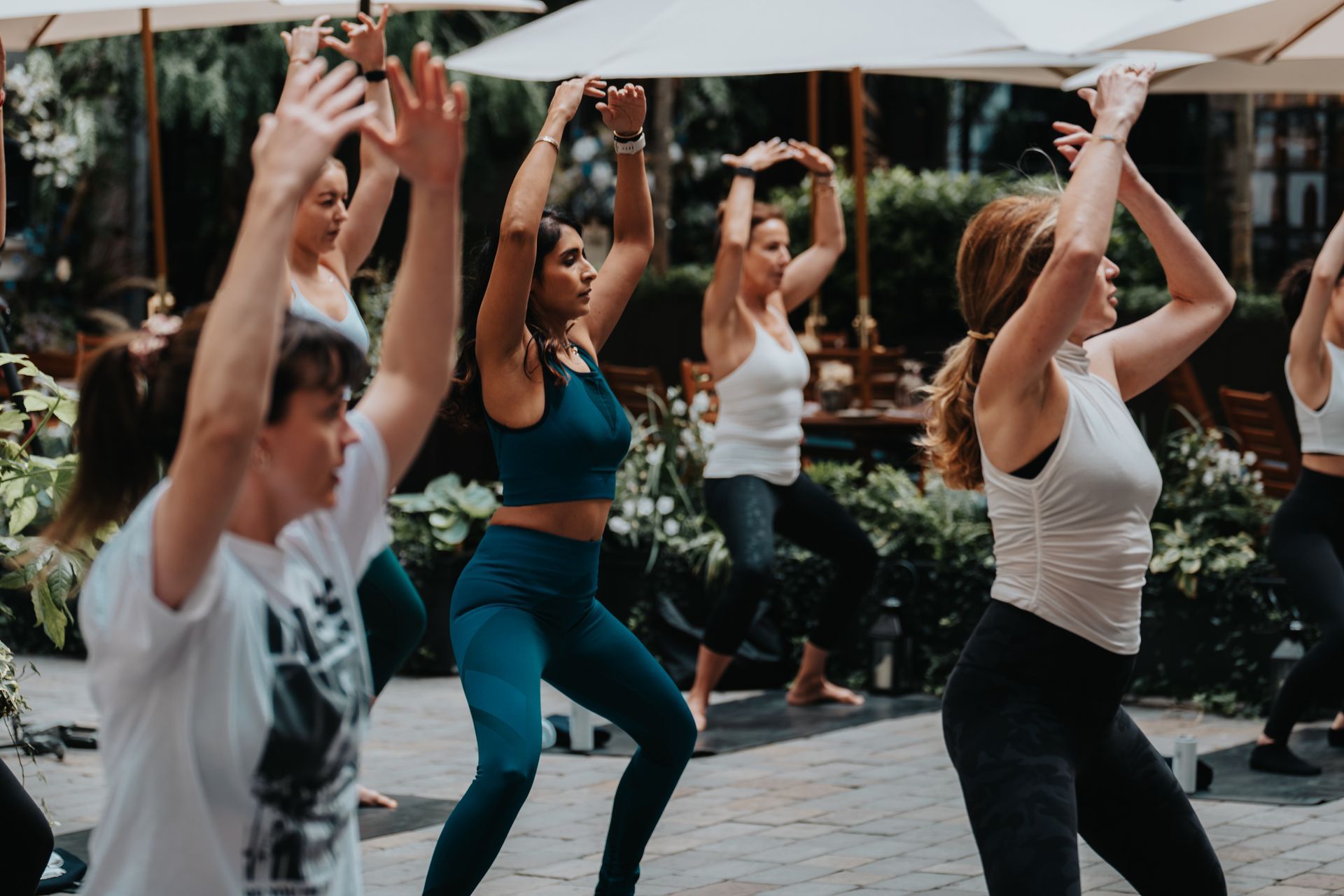 A group of people are doing exercises in a park.