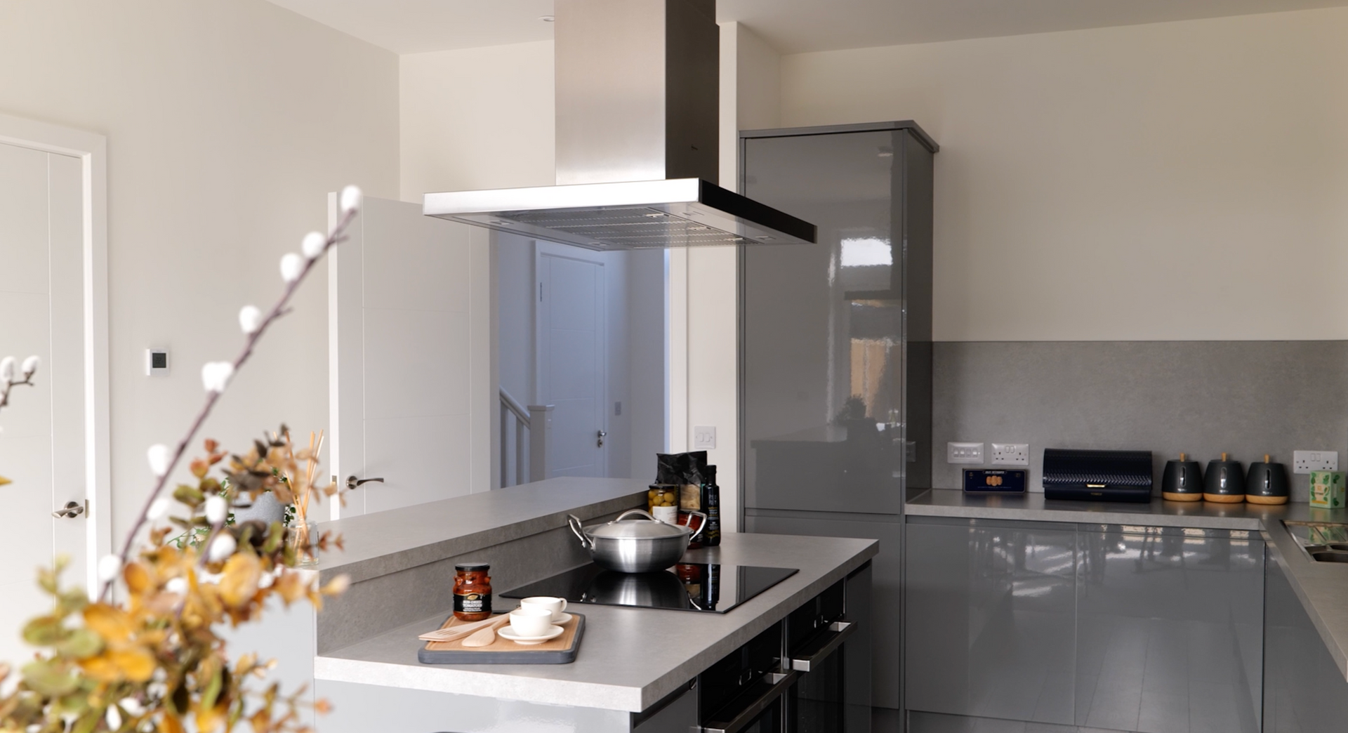 A kitchen with a stove top oven and a pot on the stove.