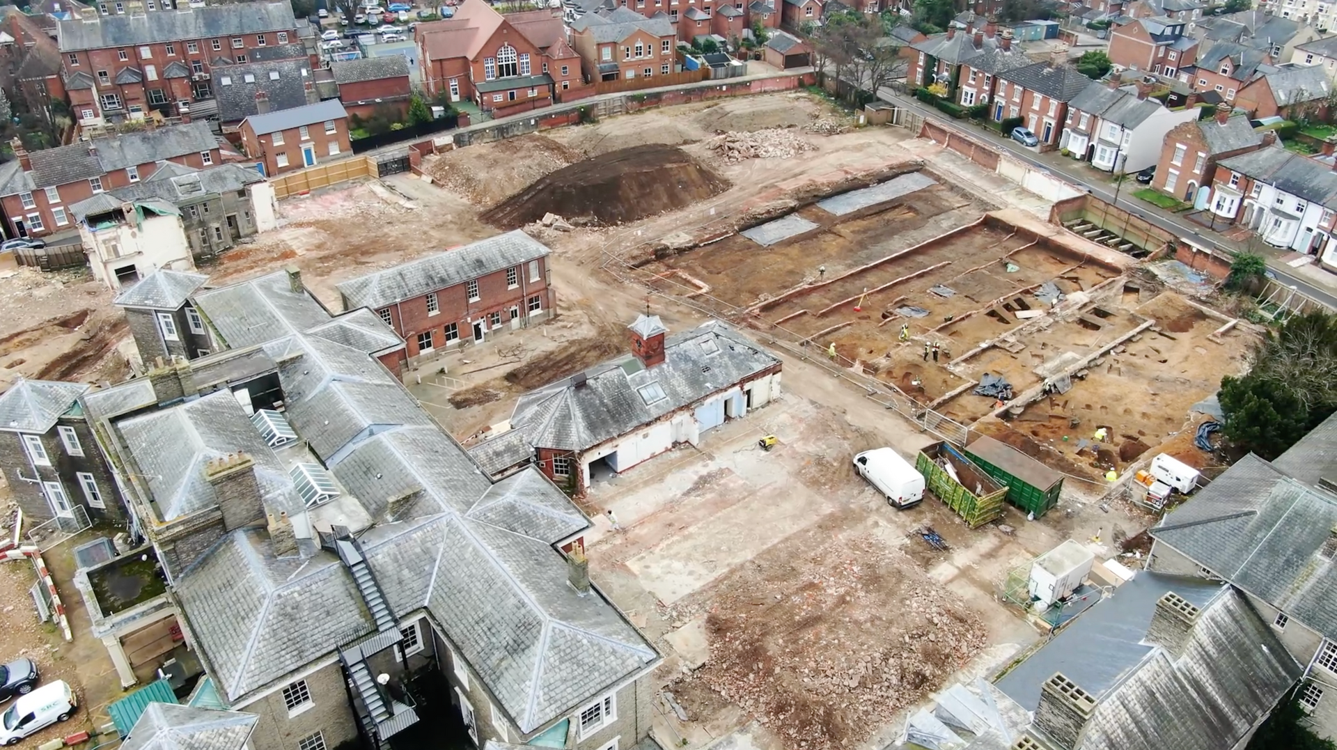 An aerial view of a building under construction in a city.