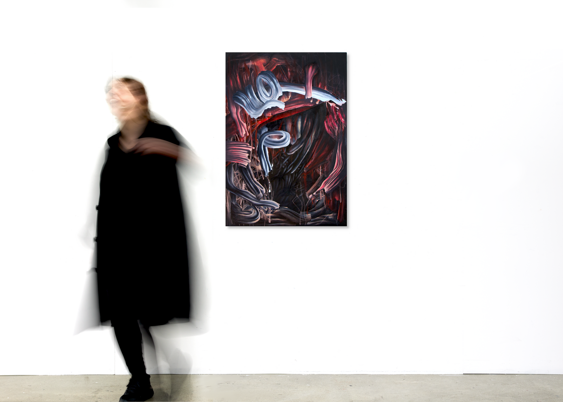 Woman in black outfit near abstract art on white wall - Lala Drona, Little Miss Perfect
