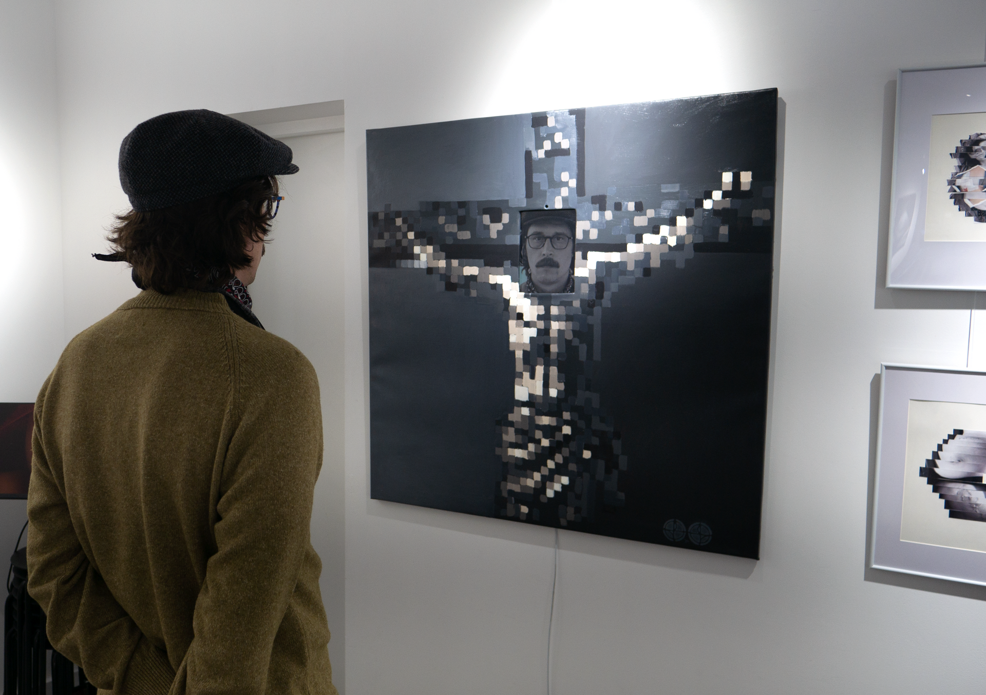Viewer at Lala Drona's exhibition seeing their reflection in Virtual Reverence