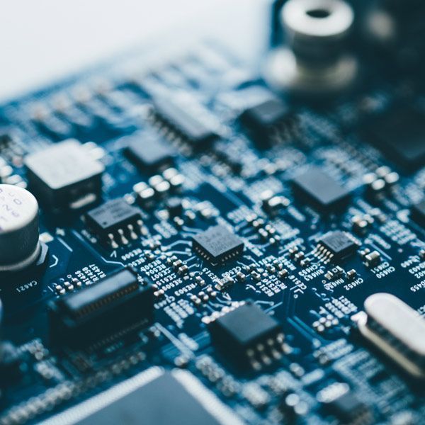 Close-up of a blue printed circuit board with electronic components and microchips