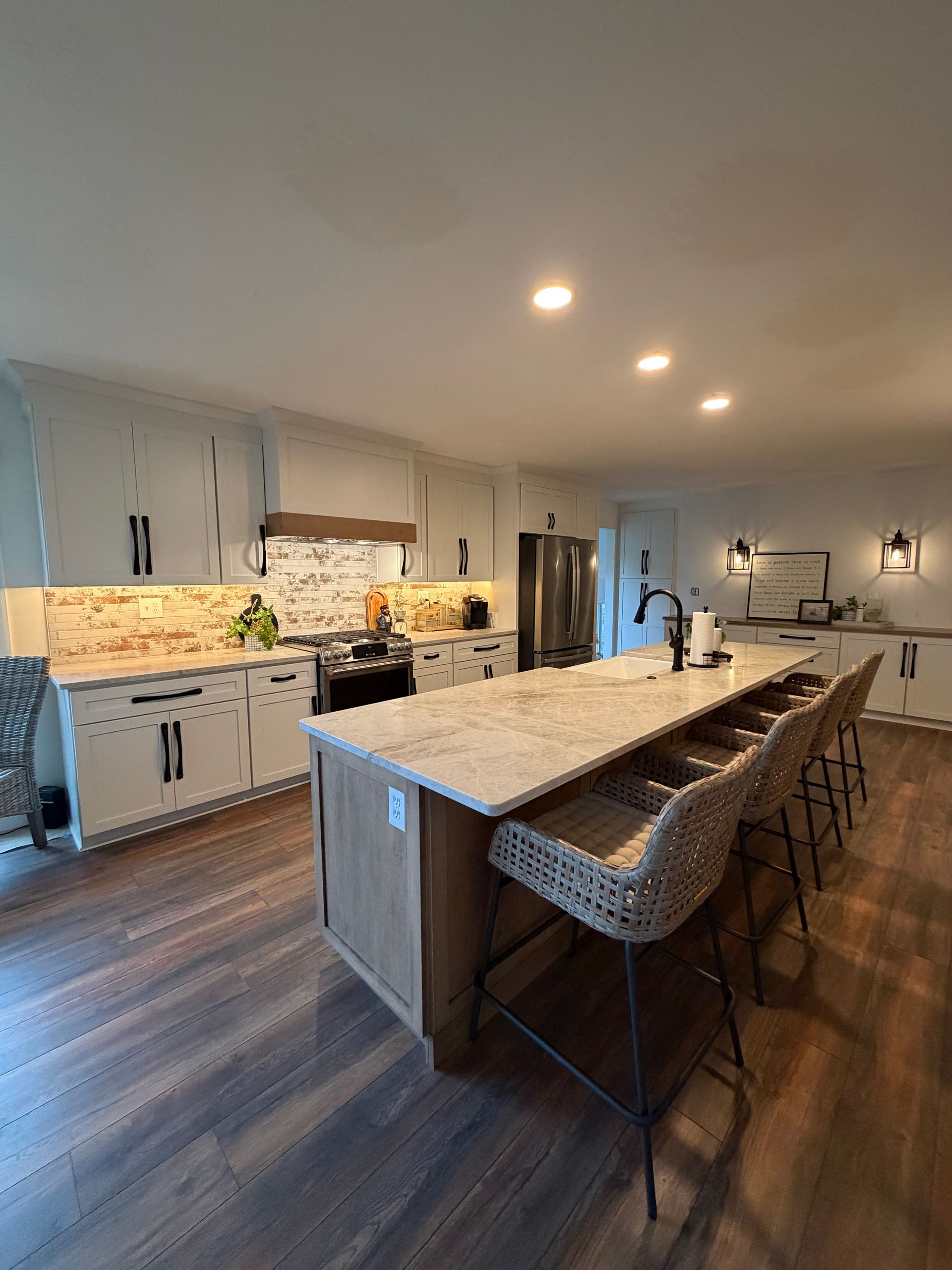 Spacious open-concept kitchen and dining area with a kitchen island and round dining table.