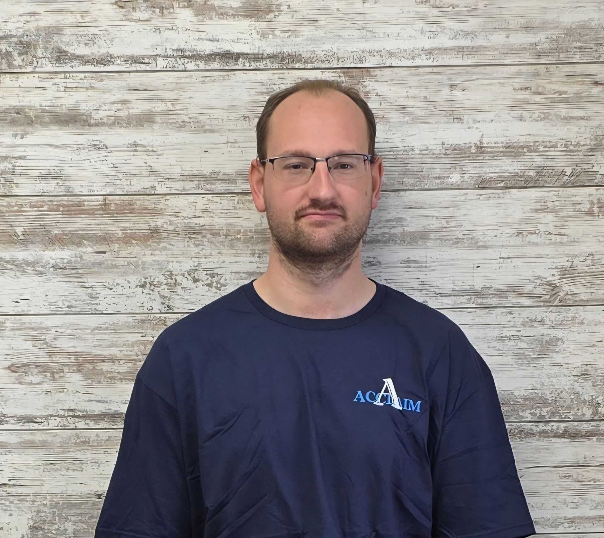Man wearing a navy shirt with the logo 