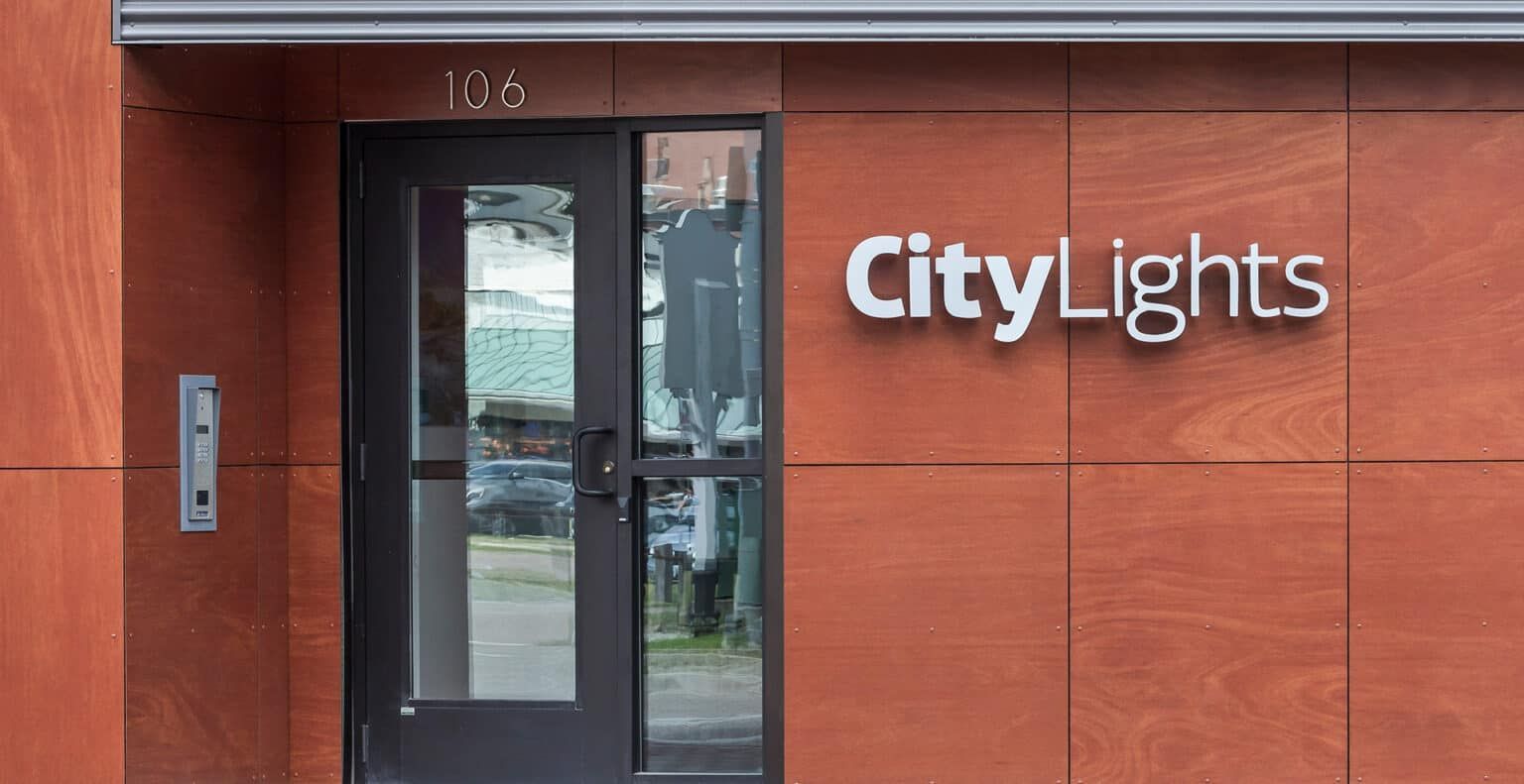A building with a door and a sign that says city lights on it.