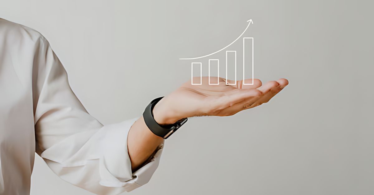 Hand in white shirt holding a glowing rising bar chart icon