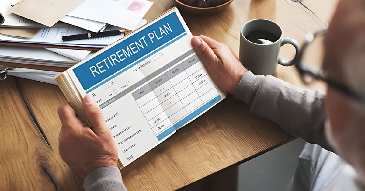 Hands holding a retirement plan booklet on a desk with coffee cup and papers nearby