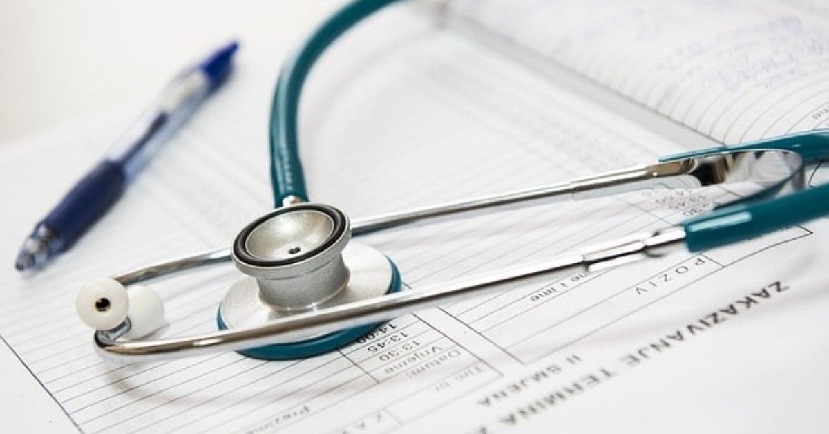 Stethoscope and pen on medical paperwork, suggesting healthcare documentation