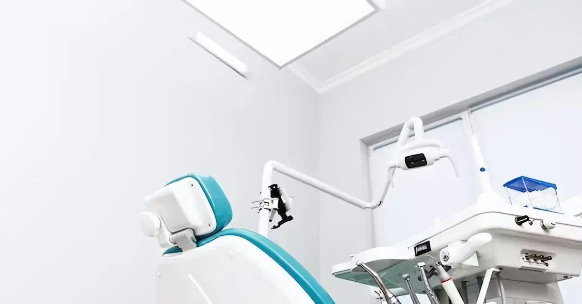 Modern dental chair and equipment in a bright, sterile clinic room