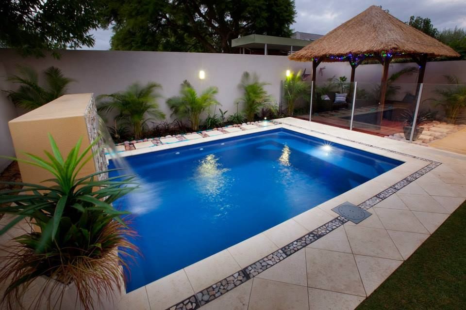 A Large Swimming Pool With a Gazebo in the Background — Gibson Family Pools Pty Ltd In Kempsey, NSW